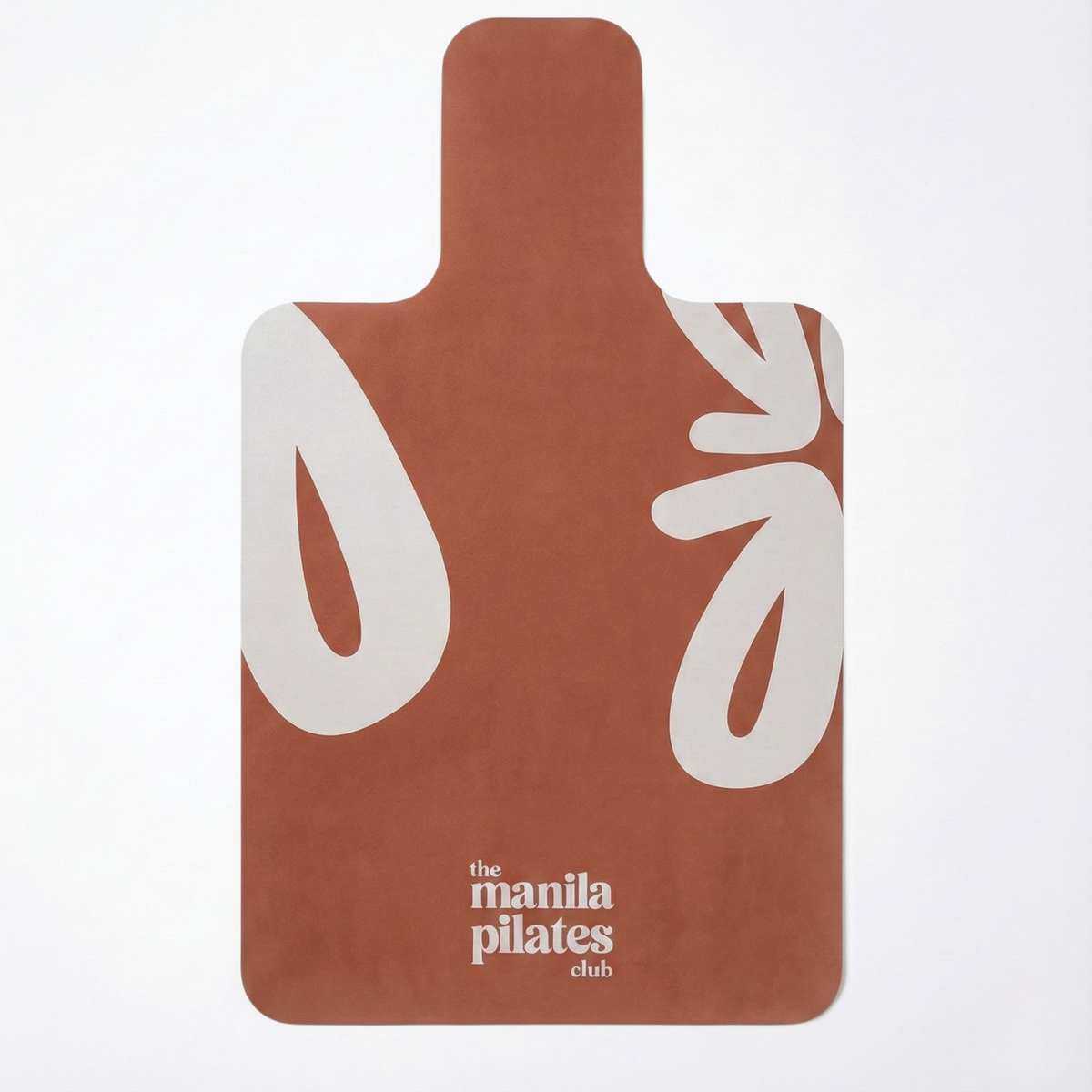 The Classic Reformer Mat in terracotta with white leaf graphics, suede Pilates mat by Tuelles