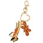Tuelles Miniformer Keychain, gold-tone mini Pilates reformer keychain with an airplane charm