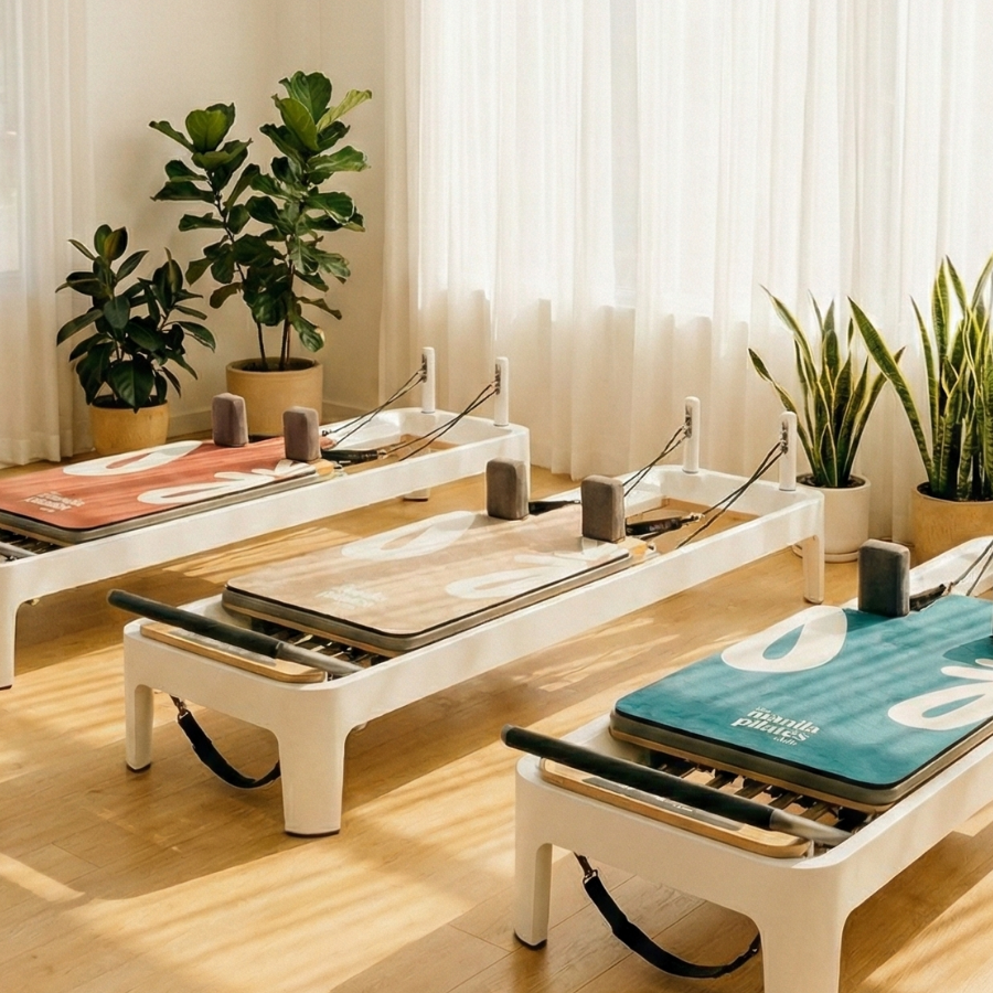 The Classic Reformer Mat on a reformer in a bright studio, suede Pilates reformer mat by Tuelles