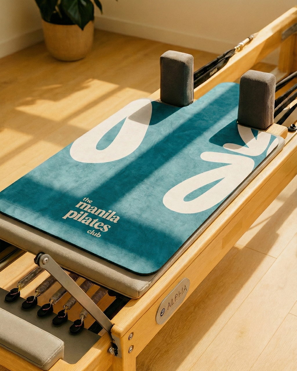 The Classic Reformer Mat in Forest Teal on a Pilates reformer, suede Pilates reformer mat by Tuelles